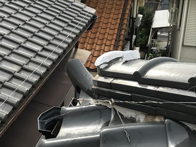 名東区で鬼瓦の交換工事を実施、既存の鬼瓦を撤去し新たな鬼瓦をワイヤーで固定する様子を紹介